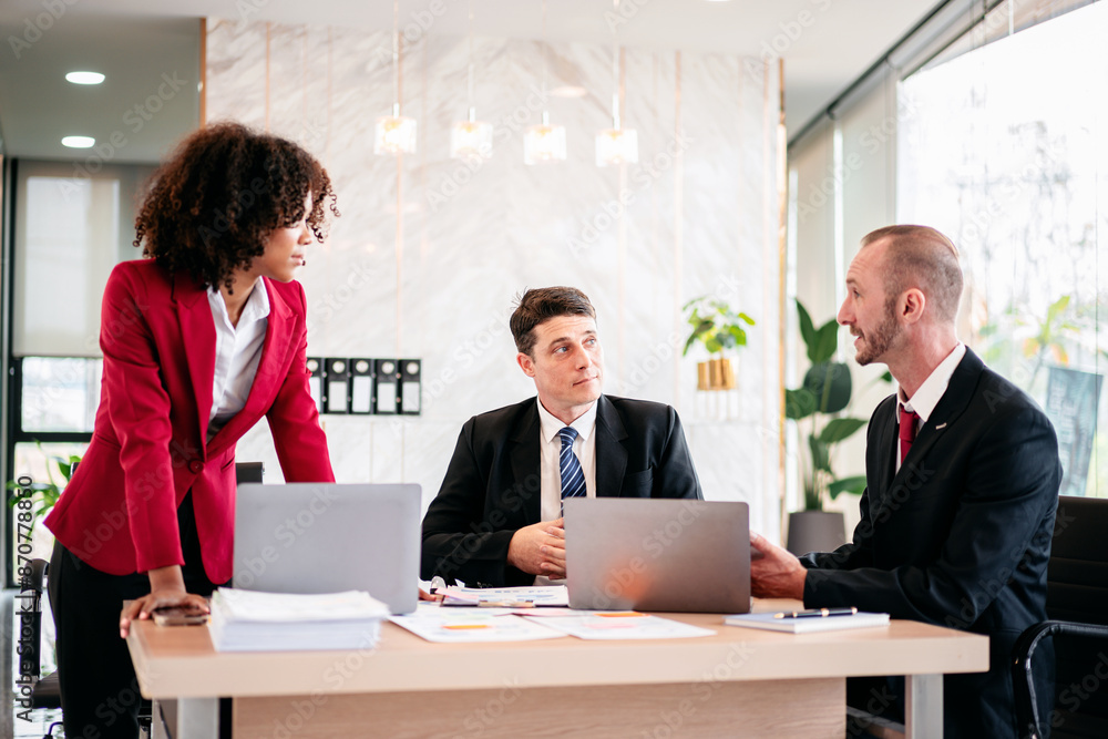 Three men and a woman are sitting at a conference table Three men and a woman are sitting at a conference table