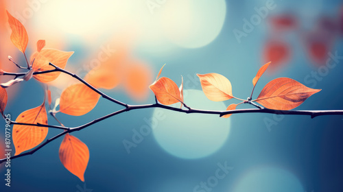 Enchanting Leaves: Closeup of Vibrant Colorful Leaves on Branch with Soft Blue and Orange Hues