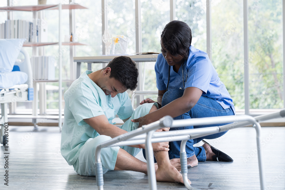 Φωτογραφία Nurse caring male patient falling from walker to the floor in patient room at hospital