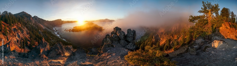 Fototapeta premium A panoramic view of a mountain range with a lake in the foreground