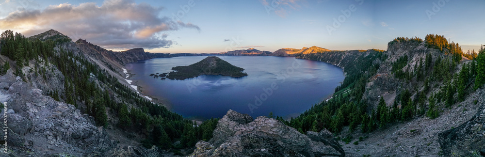 A panoramic view of a lake with mountains in the background A panoramic view of a lake with mountains in the background
