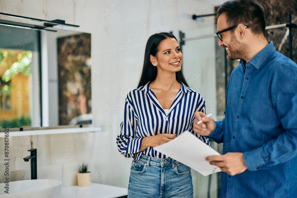 Obraz premium Female and male creating a contract of sale in a furniture store.
