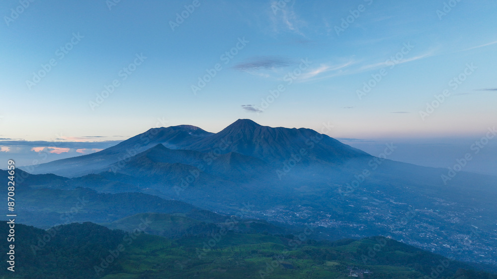 Aerial view of Gede Pangrango Mount from the top of Mount Kencana, with bright blue skies and covered in beautiful mist and clouds Bogor - West Java Indonesia