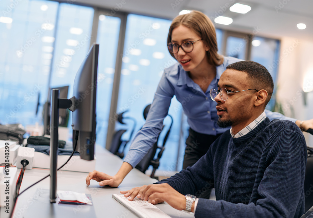 Digital Collaboration: Blonde Businesswoman and African American Partner Reviewing Documents Online Digital Collaboration: Blonde Businesswoman and African American Partner Reviewing Documents Online