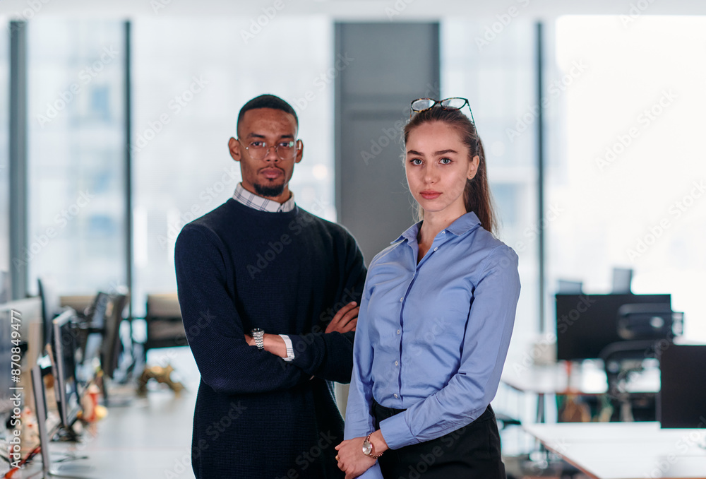 Dynamic Business Collaboration: Blonde Businesswoman and African American Colleague in Modern Office Setting. Dynamic Business Collaboration: Blonde Businesswoman and African American Colleague in Modern Office Setting.