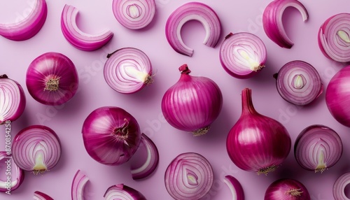  cut fresh red onions falling on light violet background 