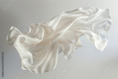 A white cloth is seen flying through the air, capturing a moment of movement and texture