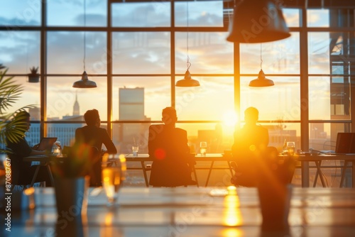 Silhouettes of People Enjoying Sunset in Modern Office