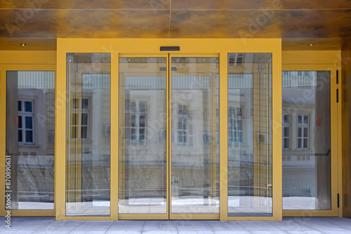 Obraz na płótnie Automatic Sliding Doors Golden Entrance to Modern Office Building w salonie