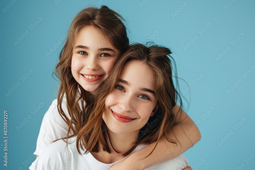 Close up photo of mother and daughter hugging happily. Close up photo of mother and daughter hugging happily.