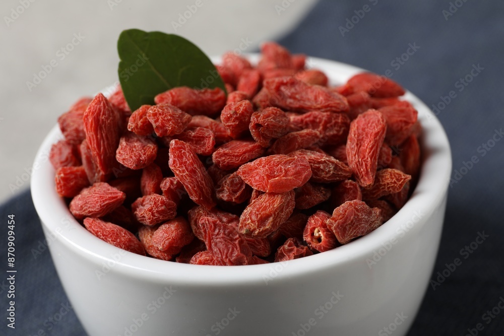 Dried goji berries in bowl on table, closeup Dried goji berries in bowl on table, closeup