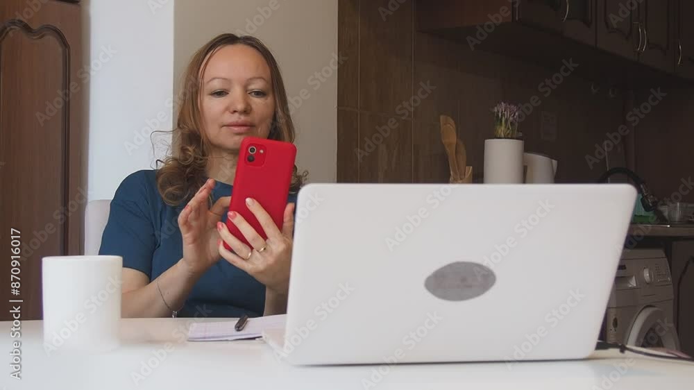 Busy woman eating, drinking coffee, talking on the phone, working on laptop at the same time. Freelancer works at home. woman in the kitchen studying online, talking on video, video call Busy woman eating, drinking coffee, talking on the phone, working on laptop at the same time. Freelancer works at home. woman in the kitchen studying online, talking on video, video call