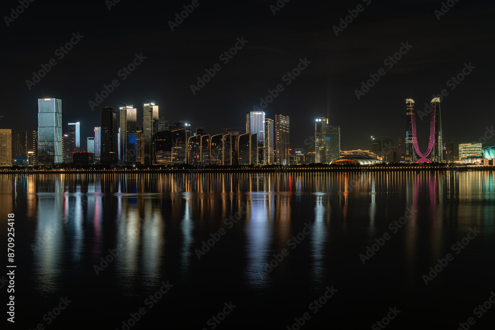 Fototapeta premium Modern city skyline and urban buildings at night in Hangzhou, China, featuring skyscrapers, city lights, nightlife, a vibrant skyline, and a blend of futuristic design landmarks in the Hangzhou CBD