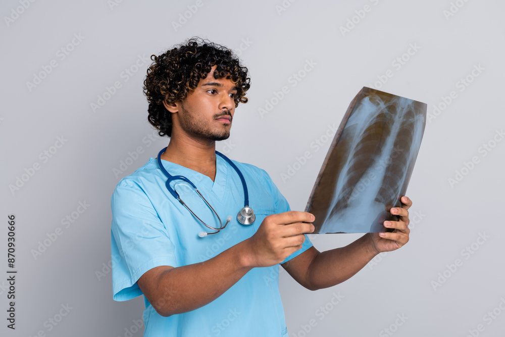 Photo of doctor guy hold x ray look check patient lungs isolated grey color background Photo of doctor guy hold x ray look check patient lungs isolated grey color background