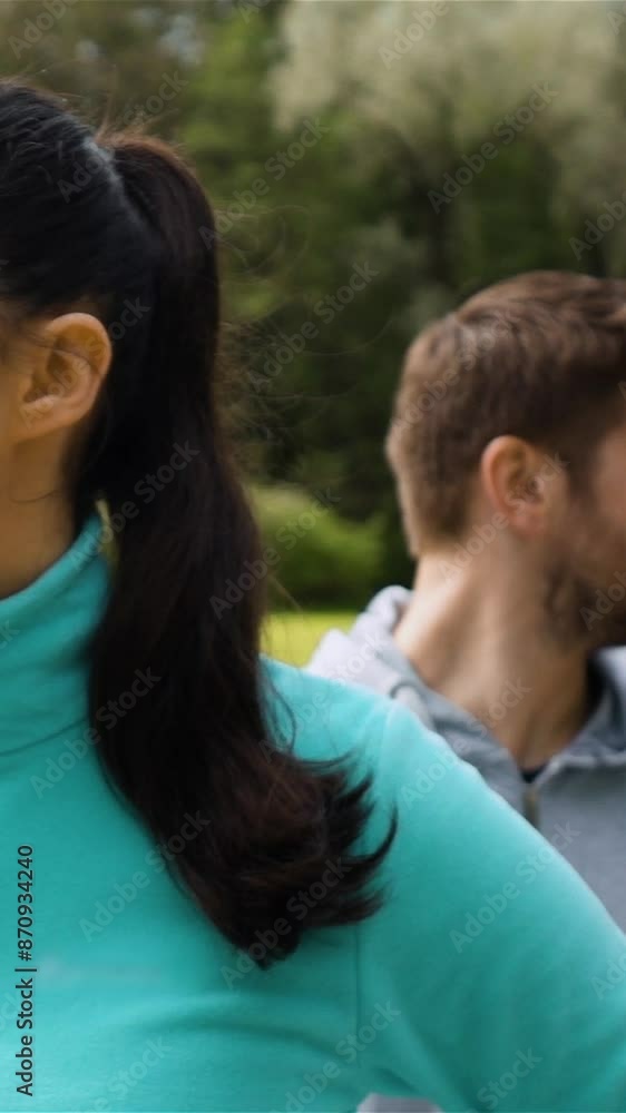 Sport couple relaxing after jogging. Woman and man runner training. Healthy active lifestyle concept. Epic turning looking eyes at camera. Female at front view. Super slow moion shot. Vertical shot. Sport couple relaxing after jogging. Woman and man runner training. Healthy active lifestyle concept. Epic turning looking eyes at camera. Female at front view. Super slow moion shot. Vertical shot.