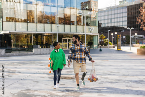 Couple Walking with Groceries and Skateboard in Urban Area © PintoArt