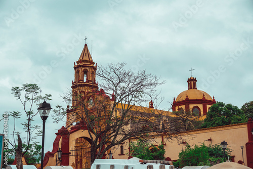 Sanctuary of the Holy Child of La Mezclita and the Apostle Santiago, one of the 5 Franciscan Missions in the Sierra Gorda of Queretaro, in Jalpan de Serra, people who go to Mass are distinguished. photo