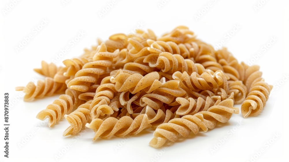 Pile of uncooked whole grain fusilli pasta on white background Pile of uncooked whole grain fusilli pasta on white background