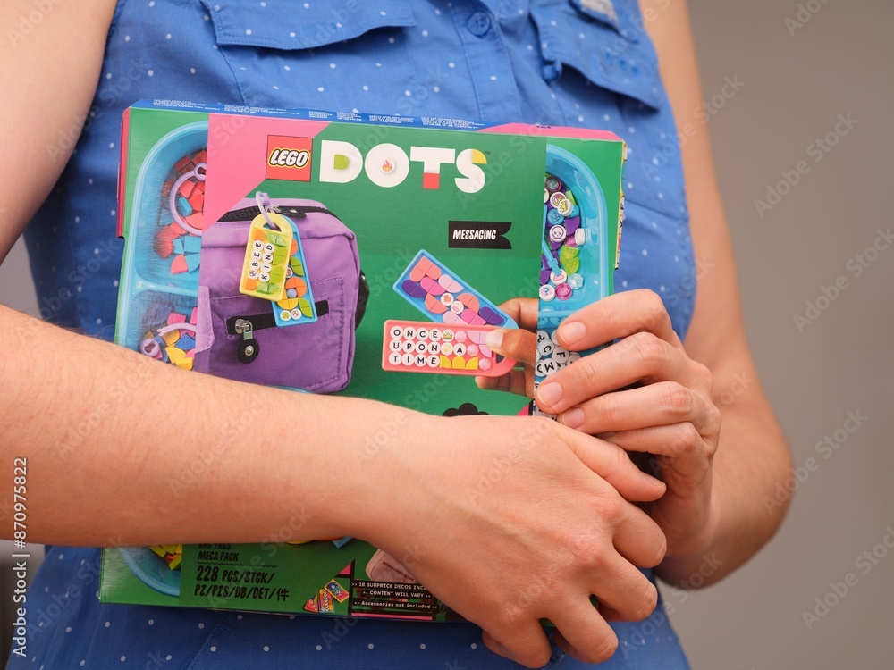 Fototapeta premium Tambov, Russian Federation - December 27, 2023 Woman holding a Lego Dots box.