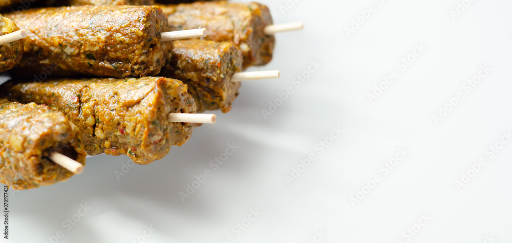 A bunch of skewers with meat on them A bunch of skewers with meat on them