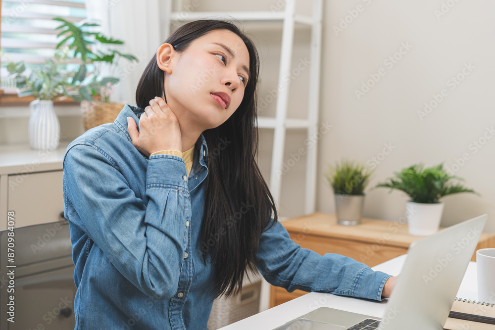 Body muscles hurt stiff, face suffering asian young woman, girl neck pain, body ache while sitting work at home, holding massaging rubbing back, problem health care of office syndrome people concept. Body muscles hurt stiff, face suffering asian young woman, girl neck pain, body ache while sitting work at home, holding massaging rubbing back, problem health care of office syndrome people concept.