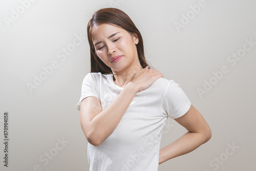 Pain body muscles stiff problem, asian young woman, girl painful with neck pain body ache from work, holding massaging rubbing shoulder hurt, sore on white background. Health care and medicine concept