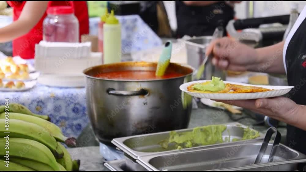 Fried platanos and avocado sauce on plate
at street food festival. Fried platanos and avocado sauce on plate
at street food festival.