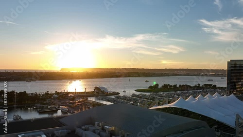 Aerial view of downtown San Diego bay and marina during si=unset in California overlooking the city skyline and Navy ships and skyscrapers with the Pacific Ocean photo