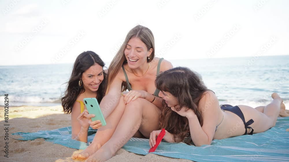 Three young women having fun taking a selfie portrait on their beach summer vacations. Group of only females wearing swimsuit shooting a photo, enjoying a a weekend on the coast. Girls at shore line Three young women having fun taking a selfie portrait on their beach summer vacations. Group of only females wearing swimsuit shooting a photo, enjoying a a weekend on the coast. Girls at shore line