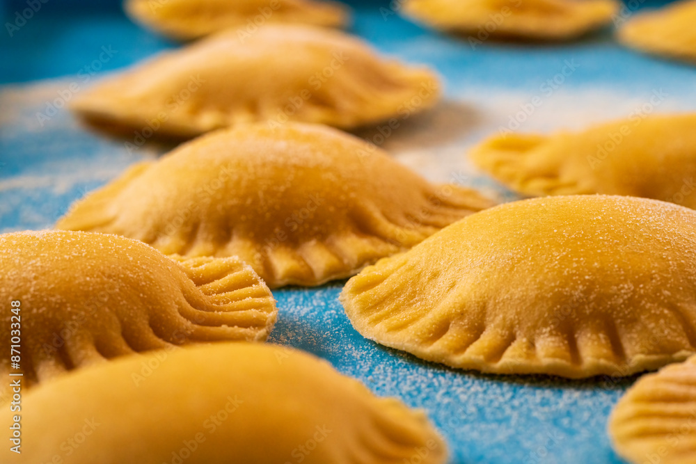 Hand made Ravioli noodles in close up view with soft bokeh background Hand made Ravioli noodles in close up view with soft bokeh background