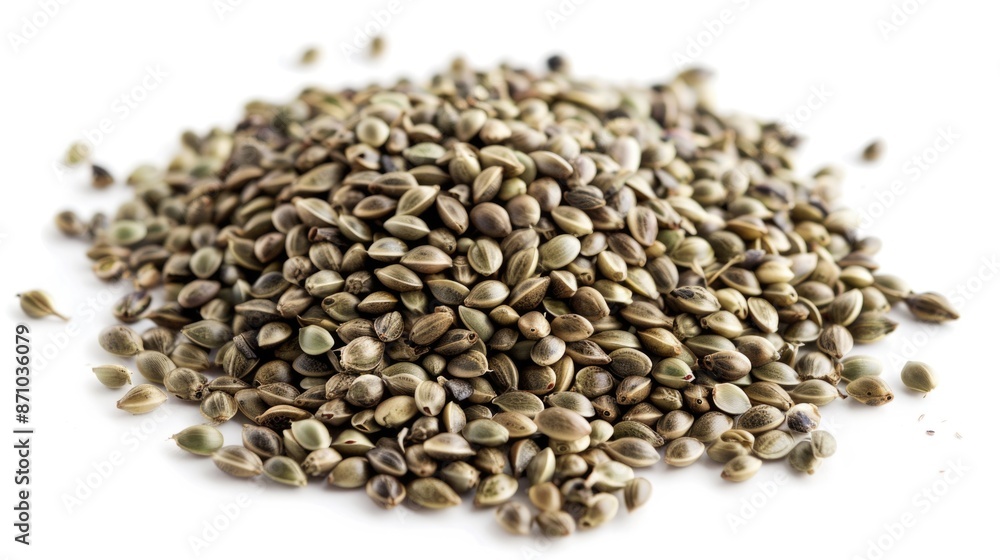 A pile of seeds on a white surface, perfect for agricultural or gardening-related themes A pile of seeds on a white surface, perfect for agricultural or gardening-related themes
