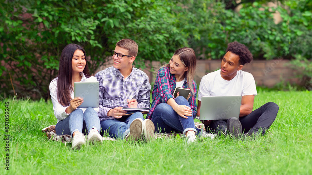 Education concept. Students with devices preparing for exams, having break at campus Education concept. Students with devices preparing for exams, having break at campus