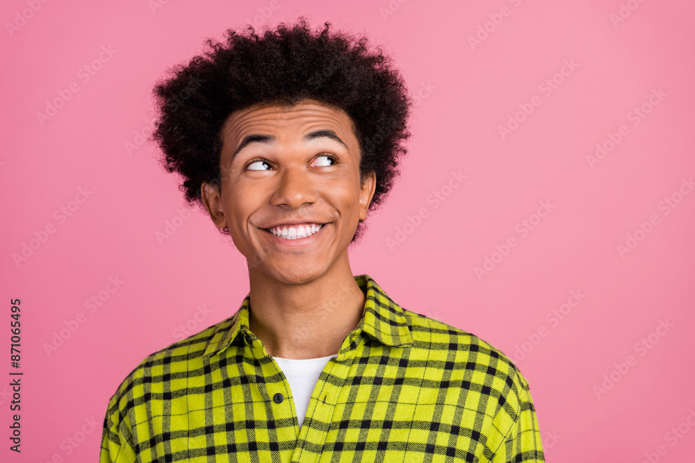 Photo of nice young man look empty space wear shirt isolated on pink color background Photo of nice young man look empty space wear shirt isolated on pink color background