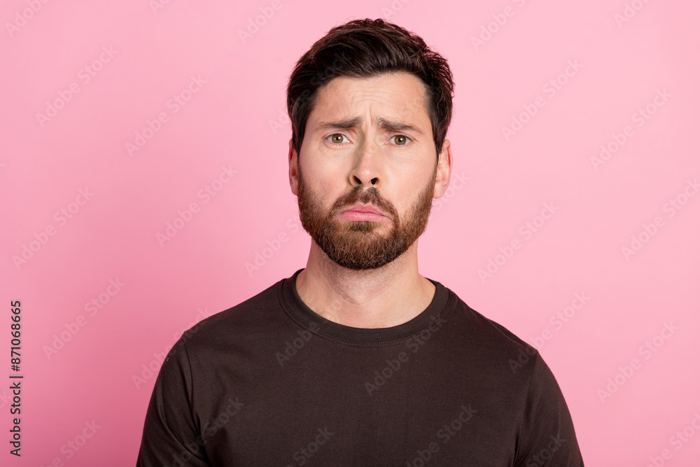 Obraz premium Portrait of sad upset gloomy man with bristle stylish hairdo wear brown shirt looking sadly at you isolated on pink color background