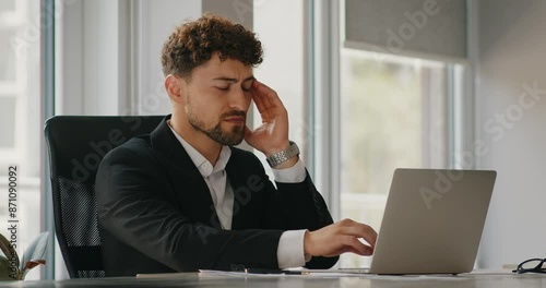 Headache and businessman with burnout, fatigue and frustrated with project and anxiety in a workplace. Person, agent and consultant with laptop and migraine with stress, medical issue and tired.