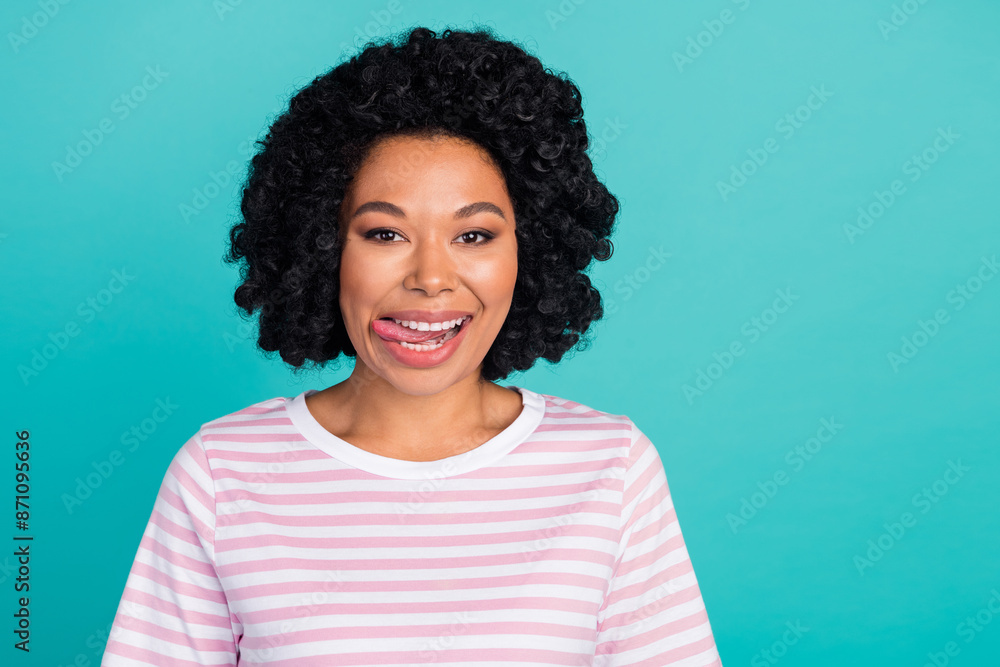 Photo portrait of pretty young girl lick teeth tasty wear trendy striped outfit isolated on aquamarine color background Photo portrait of pretty young girl lick teeth tasty wear trendy striped outfit isolated on aquamarine color background