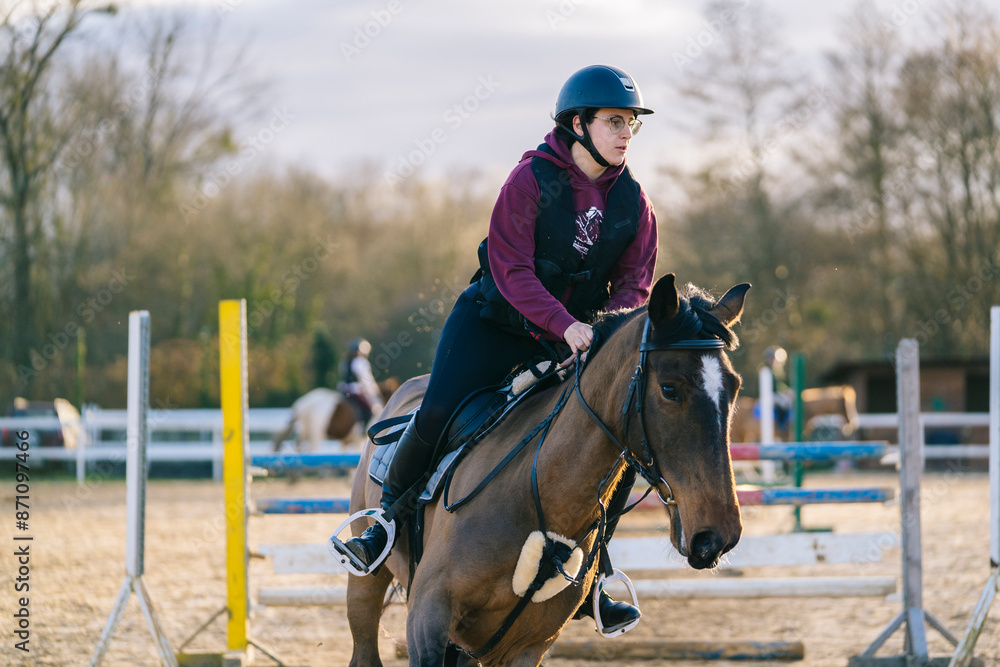 Young woman riding horse after jump Young woman riding horse after jump