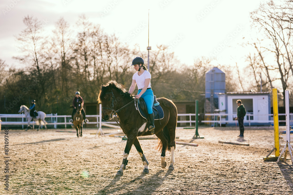 Young woman learning to ride horse Young woman learning to ride horse
