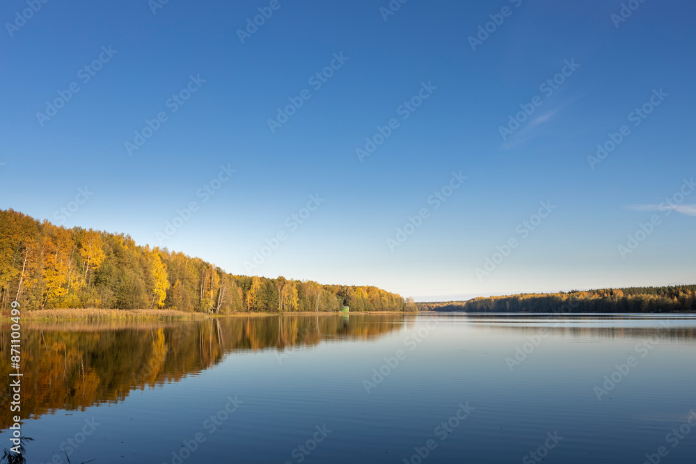 Fototapeta premium A calm lake with a blue sky in the background
