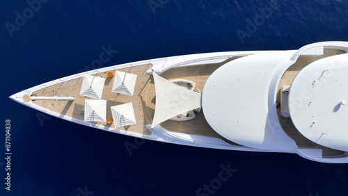 Bild auf Leinwand Aerial drone top down photo of luxury yacht with wooden deck anchored in deep bl
