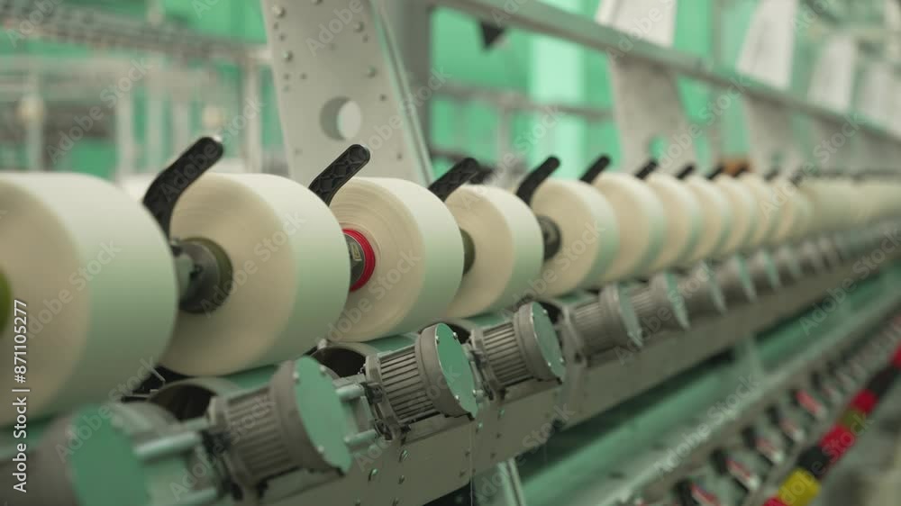 Spools of thread on textile machine. Concept of precision manufacturing Spools of thread on textile machine. Concept of precision manufacturing