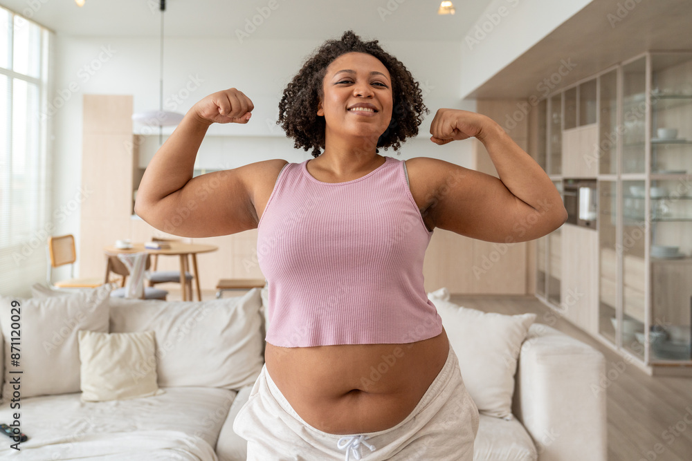 Plus Size Woman Flexing Muscles in Living Room Plus Size Woman Flexing Muscles in Living Room
