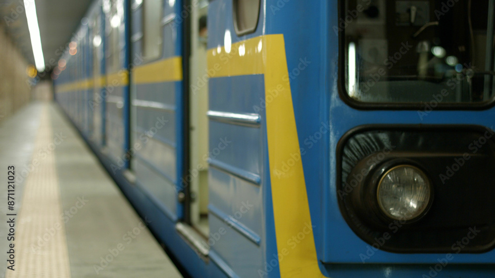 Beautiful modern metro train at the station. A blue-yellow subway train leaves for the next station. Beautiful modern metro train at the station. A blue-yellow subway train leaves for the next station.