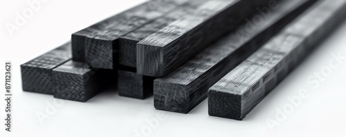 Assortment of square carbon fiber bars in different sizes on a white background photo