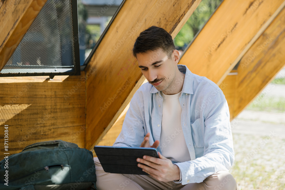 College Student Studying Outdoors using tablet College Student Studying Outdoors using tablet