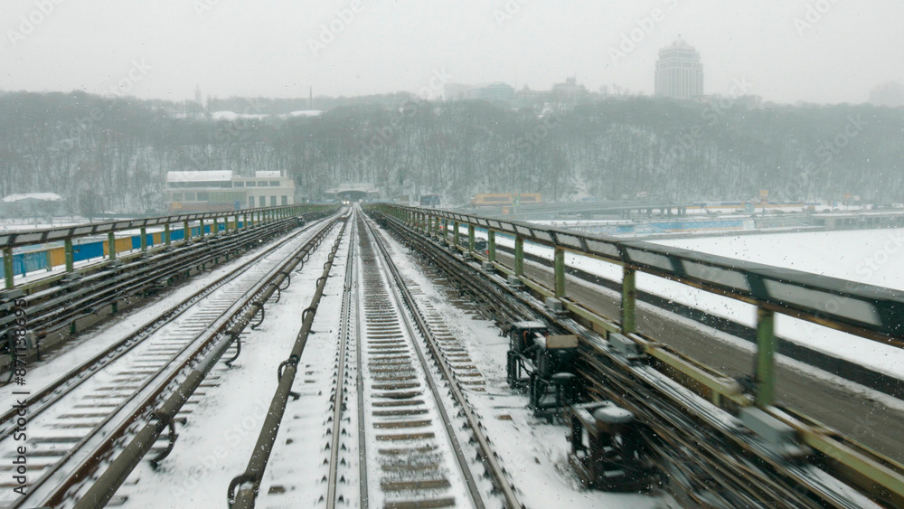 Transportation by rail. Movement of trains on winter bridge. View from the driver's cab. Transportation by rail. Movement of trains on winter bridge. View from the driver's cab.