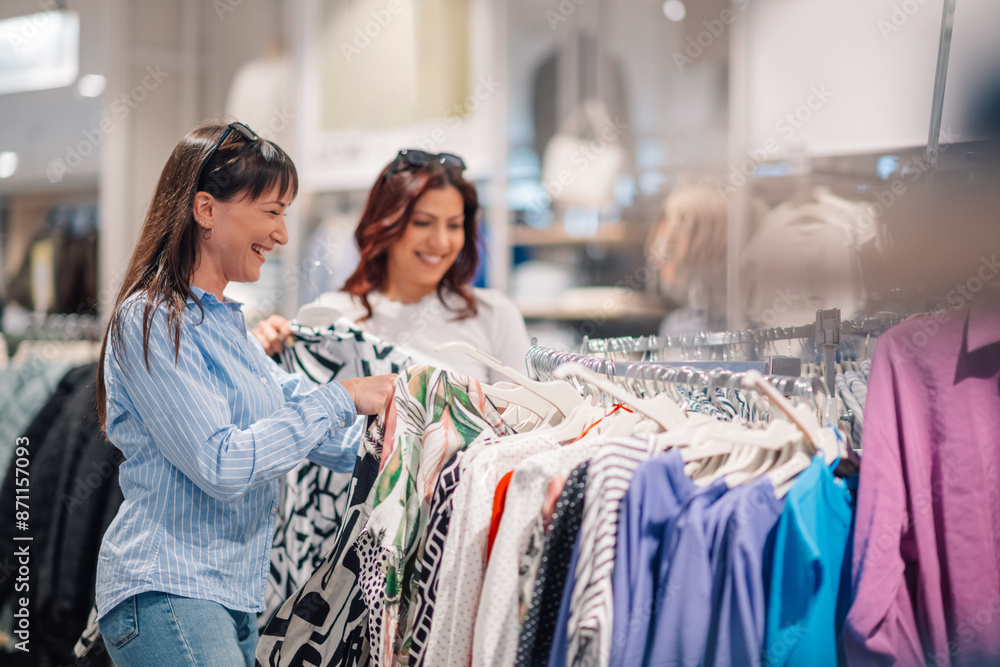 Smiling female customers at boutique choosing and shopping dress. Smiling female customers at boutique choosing and shopping dress.
