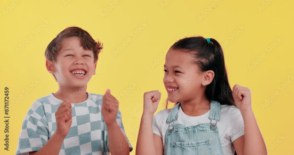 Kids, happy and celebration on studio background with cheering for success, achievement and good news. Boy, girl and smile with face, excited and energy for winner, award and victory or champion Kids, happy and celebration on studio background with cheering for success, achievement and good news. Boy, girl and smile with face, excited and energy for winner, award and victory or champion