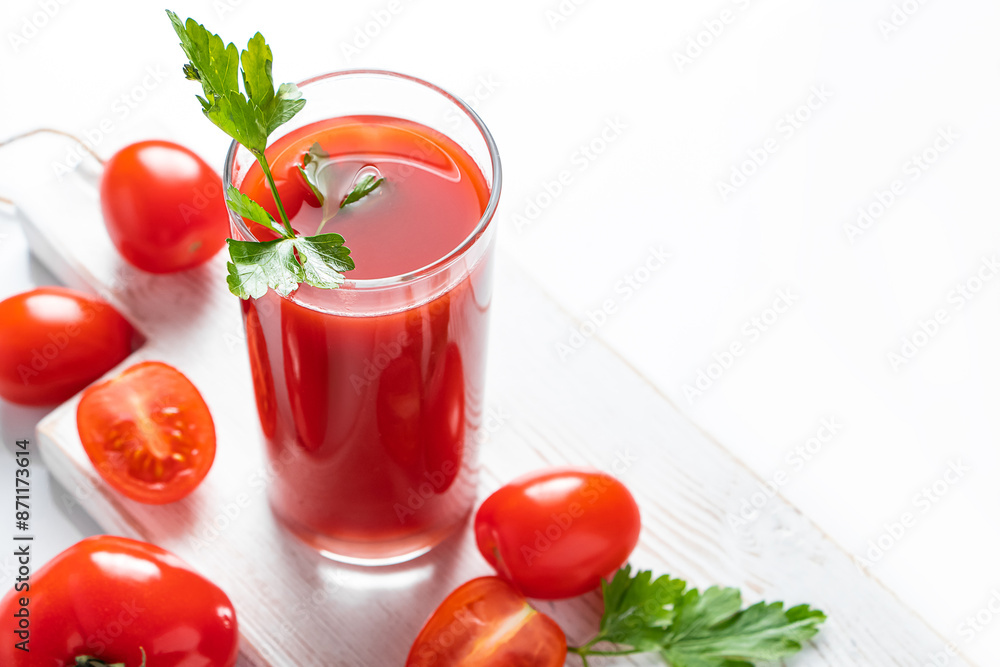 Refreshing tomato juice with parsley on a white background. Vegan vegetable smoothie. Refreshing tomato juice with parsley on a white background. Vegan vegetable smoothie.