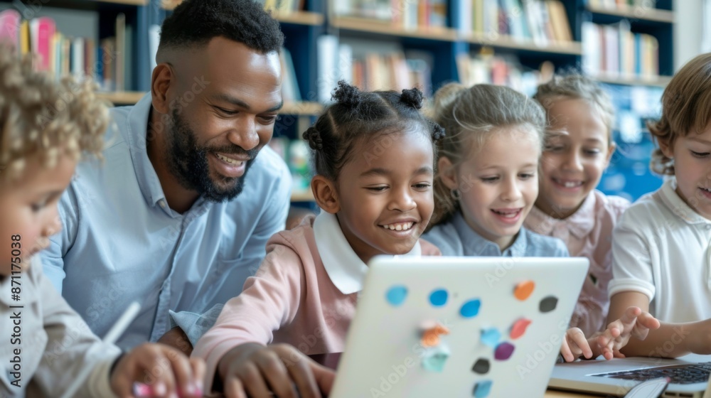 custom made wallpaper toronto digitalA male teacher oversees a group of diverse students as they engage in educational activities on their laptops within a bright and well-resourced classroom filled with books.
